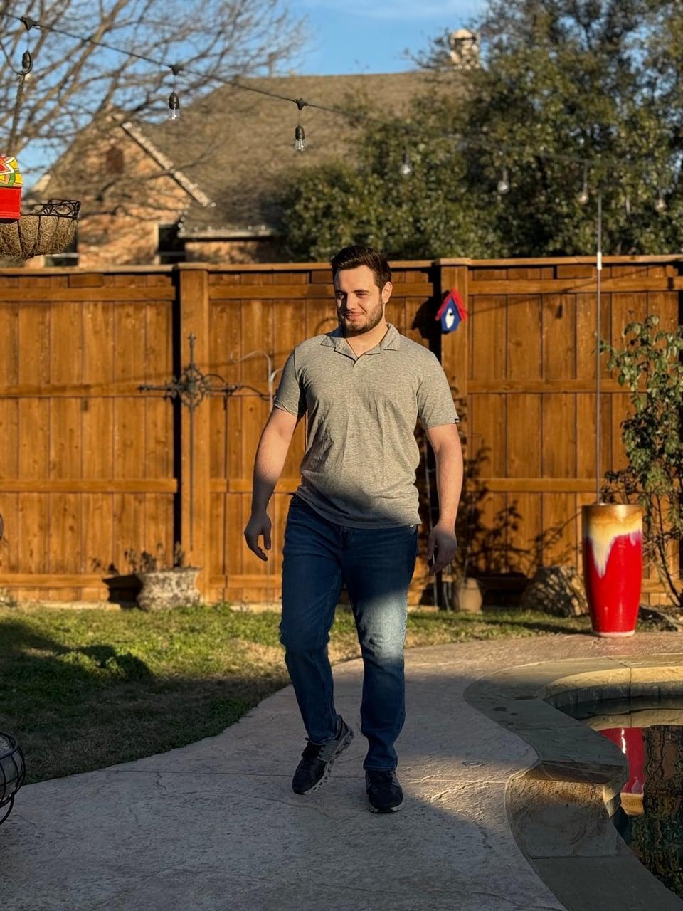 Christopher standing in a yard